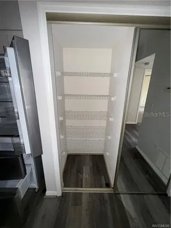 a view of walk in closet with empty racks