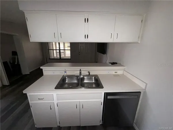 a kitchen with a sink and cabinets