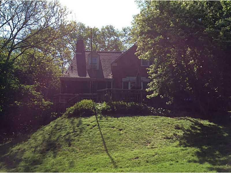 Exterior Back. Looking up to the house from the backyard.