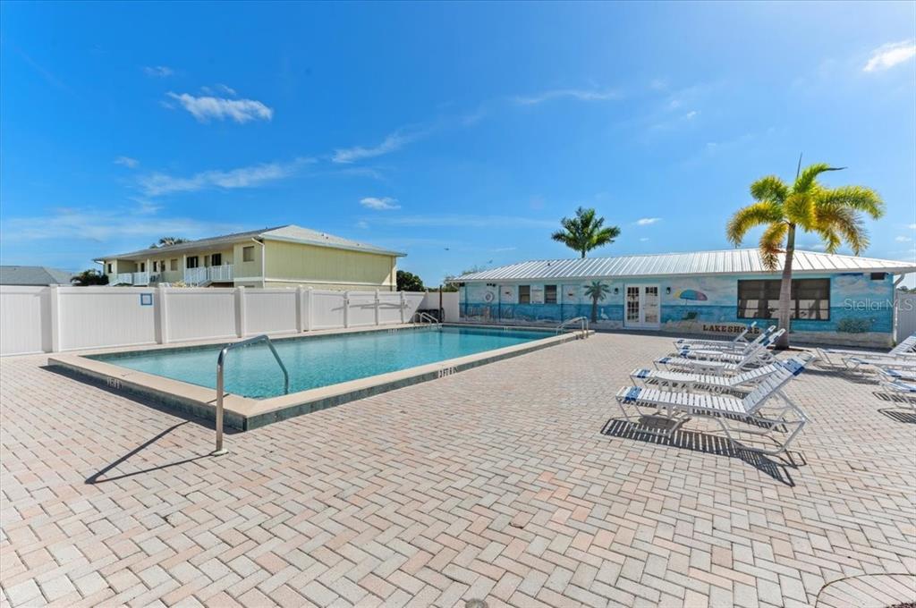 25225 Rampart Boulevard, Unit 1207 Punta Gorda, FL 33983 - Photo 32 of 40 a view of a swimming pool with a lounge chairs
