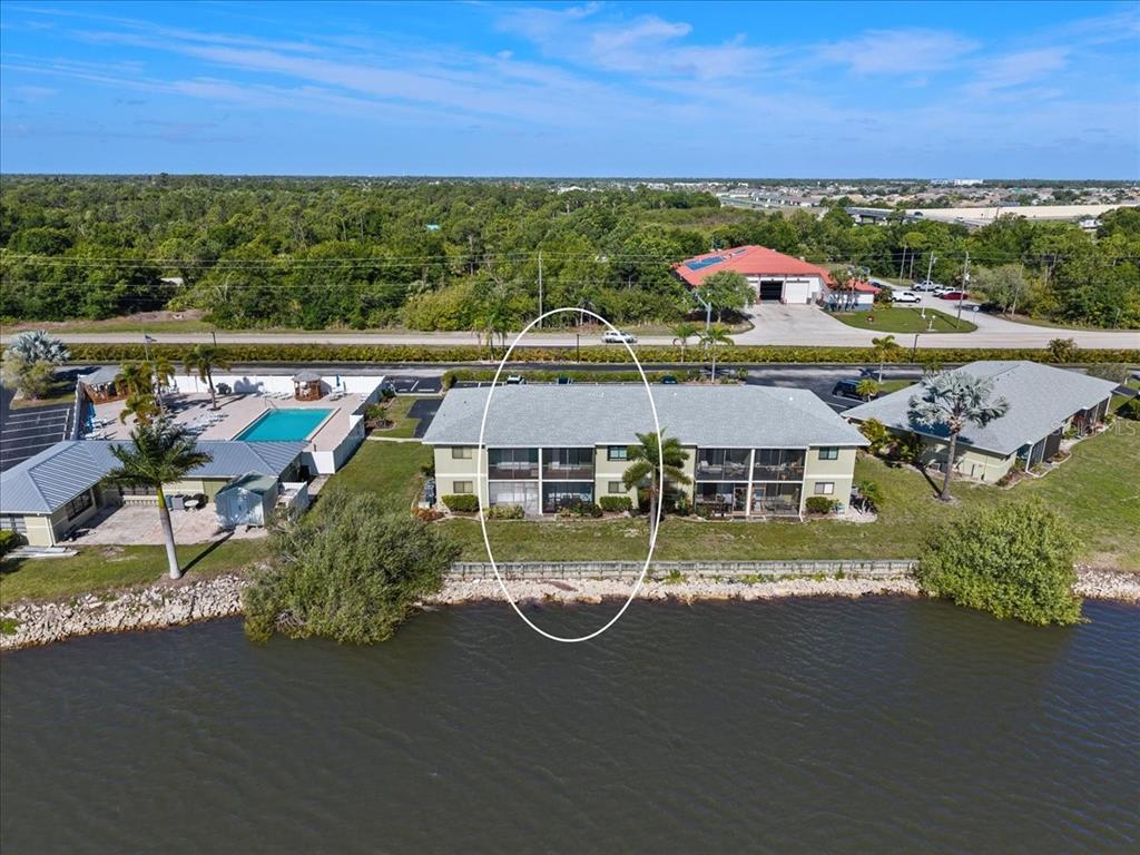 25225 Rampart Boulevard, Unit 1207 Punta Gorda, FL 33983 - Photo 35 of 40 a view of a city with lawn chairs under an umbrella