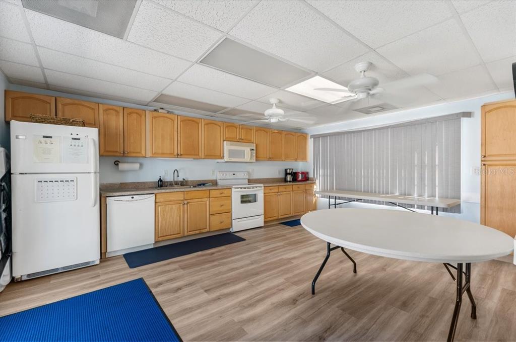 25225 Rampart Boulevard, Unit 1207 Punta Gorda, FL 33983 - Photo 40 of 40 a kitchen with a table chairs refrigerator and cabinets