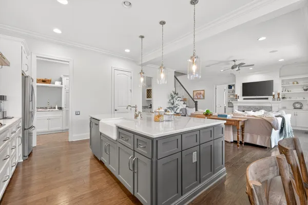 a spacious bedroom with a bed and wooden floor