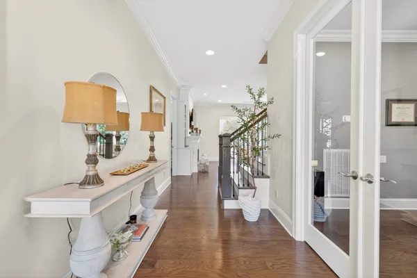 a kitchen with stainless steel appliances granite countertop a table chairs stove and wooden floor