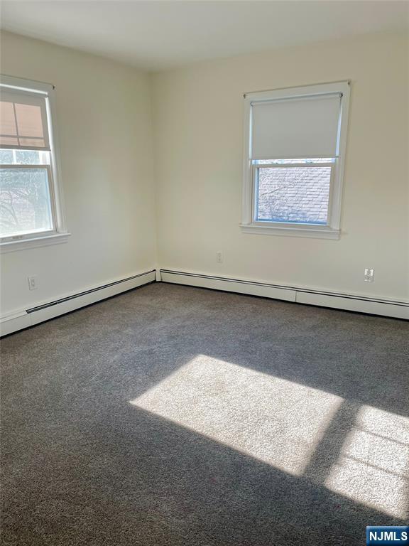 116 Post Avenue Hawthorne, NJ 07506 - Photo 13 of 18 an empty room with wooden floor and windows