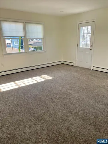 a view of balcony with wooden floor and seating space