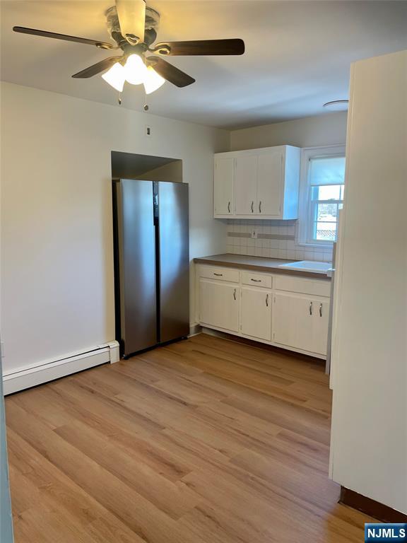 116 Post Avenue Hawthorne, NJ 07506 - Photo 2 of 18 an empty room with wooden floor a ceiling fan and windows