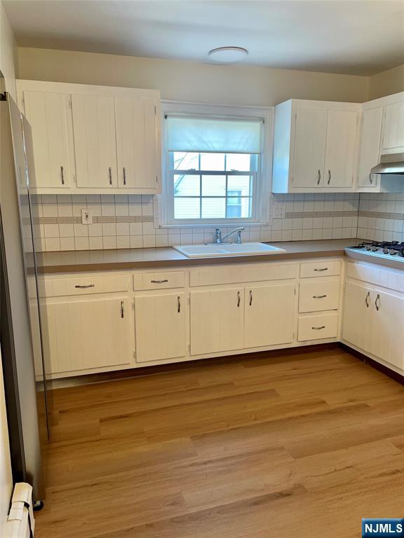116 Post Avenue Hawthorne, NJ 07506 - Photo 3 of 18 a kitchen with granite countertop white cabinets and white appliances