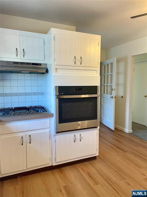 116 Post Avenue Hawthorne, NJ 07506 - Photo 4 of 18 a kitchen with granite countertop white cabinets and white appliances