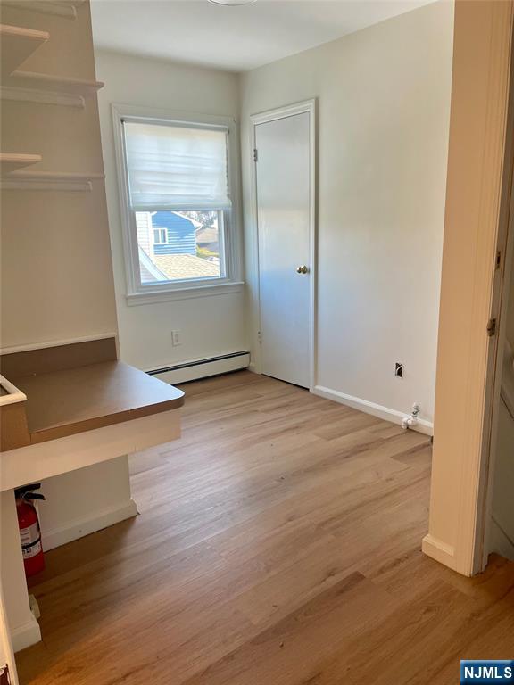 116 Post Avenue Hawthorne, NJ 07506 - Photo 5 of 18 an empty room with wooden floor and windows