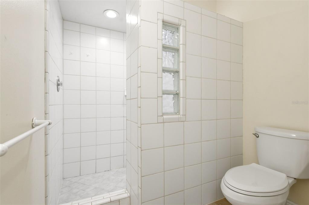 7432 Sparkling Lake Road Orlando, FL 32819 - Photo 26 of 54 a white toilet sitting next to a bathroom sink