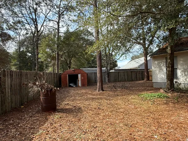 a backyard of a house with table and chairs