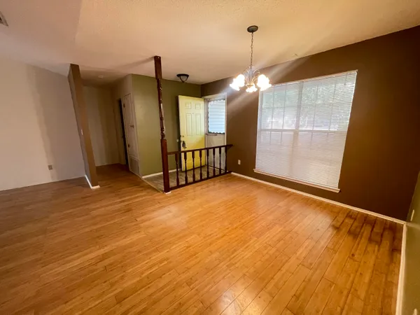 a view of a room with stairs and wooden floor