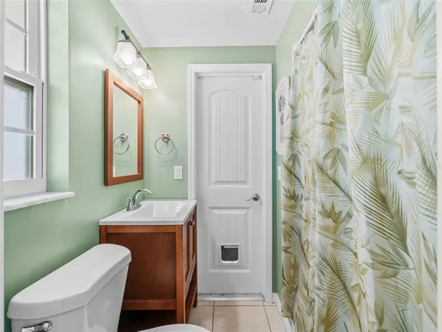 a bathroom with a sink a toilet and a shower