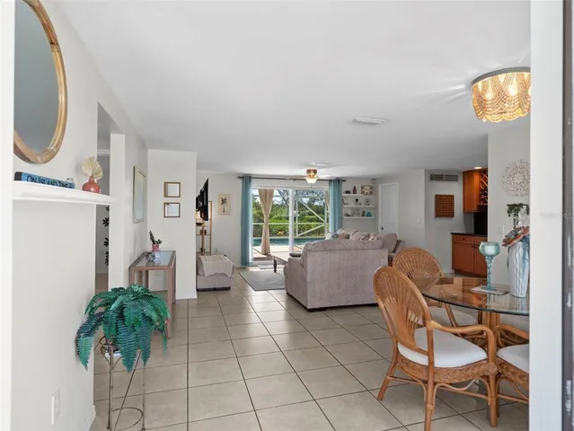 a dining room with furniture a window and wooden floor