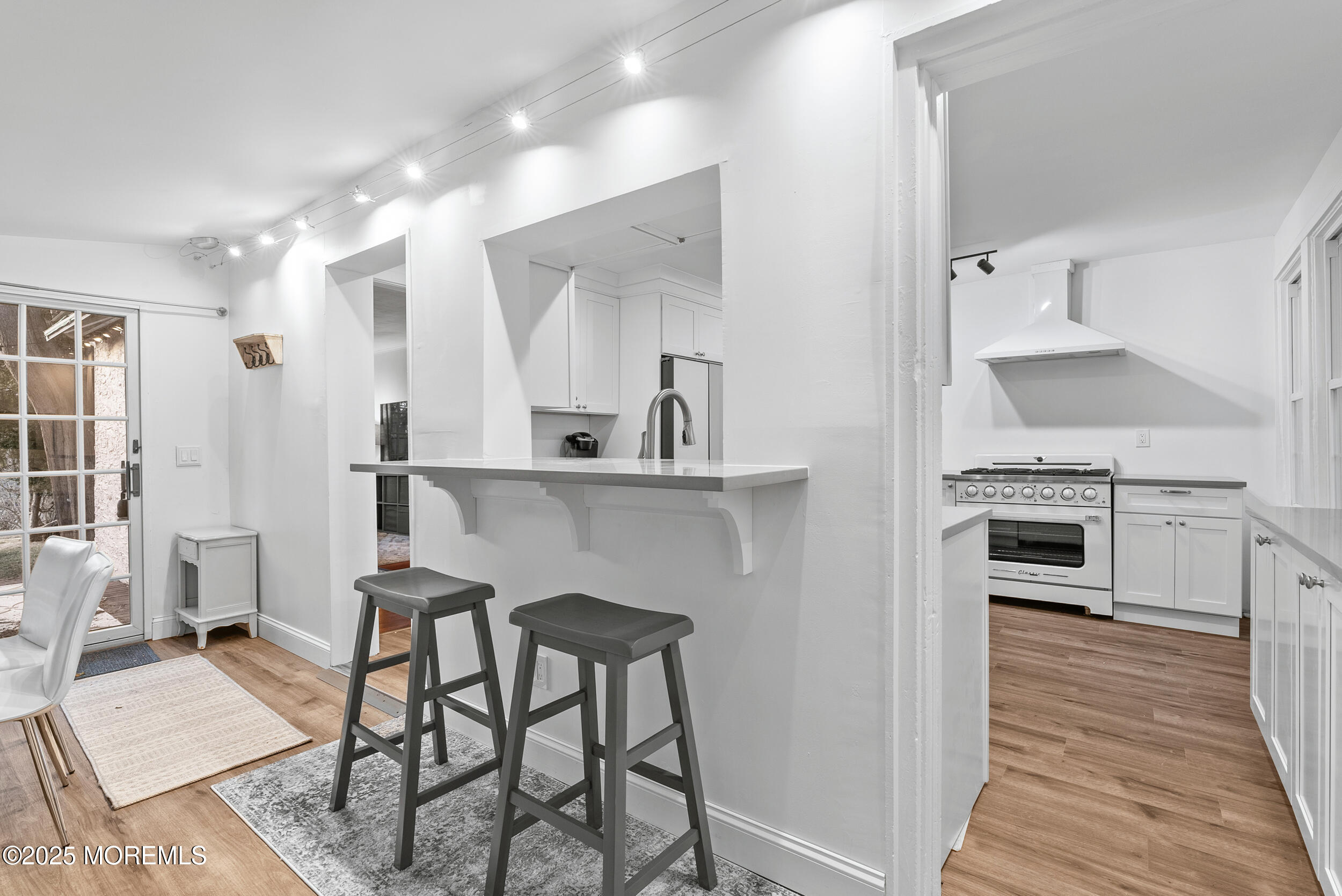 90 Deal Esplanade Deal, NJ 07723 - Photo 11 of 25 a kitchen with a table and chairs in it