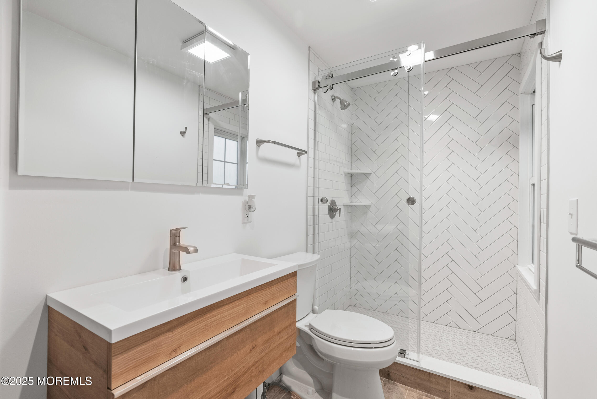 90 Deal Esplanade Deal, NJ 07723 - Photo 13 of 25 a bathroom with a sink a toilet and shower