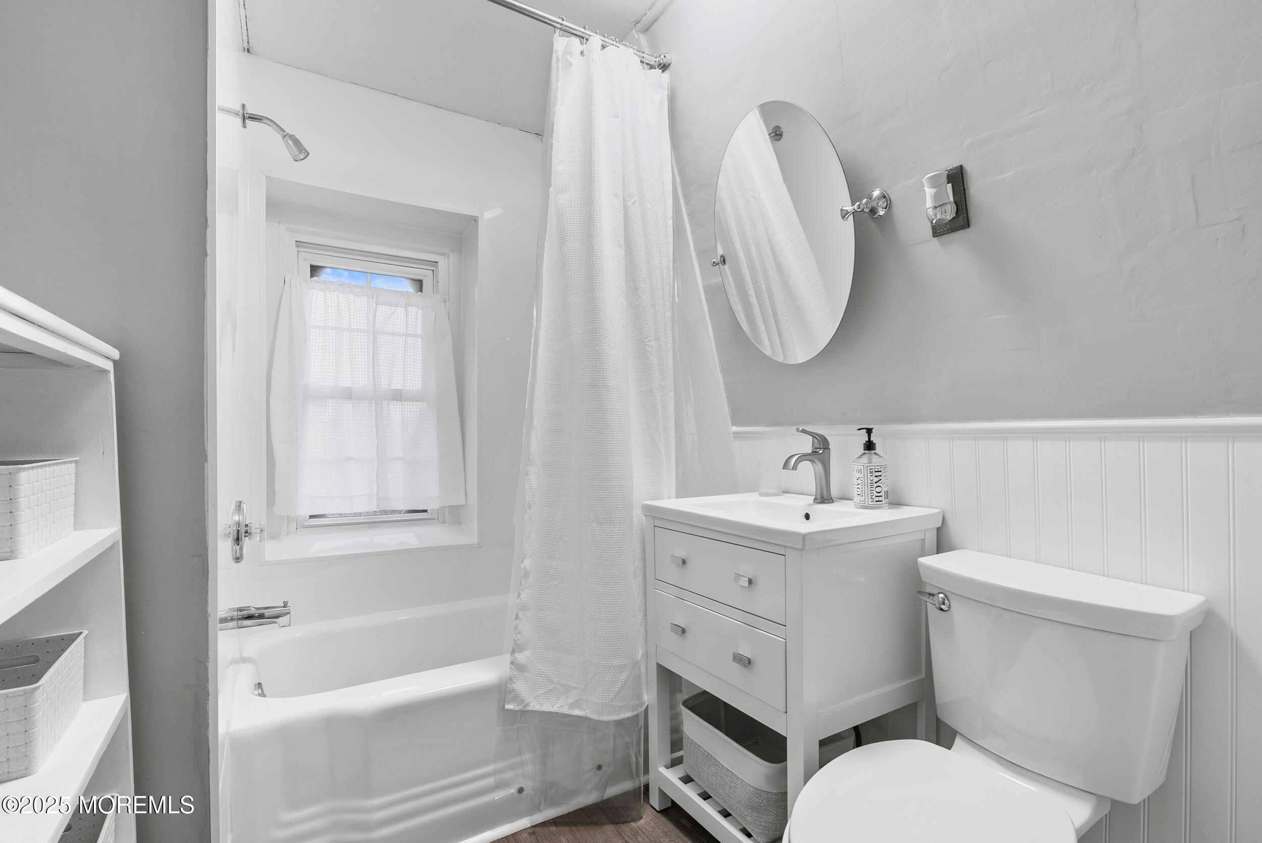 90 Deal Esplanade Deal, NJ 07723 - Photo 16 of 25 a bathroom with a toilet sink and mirror