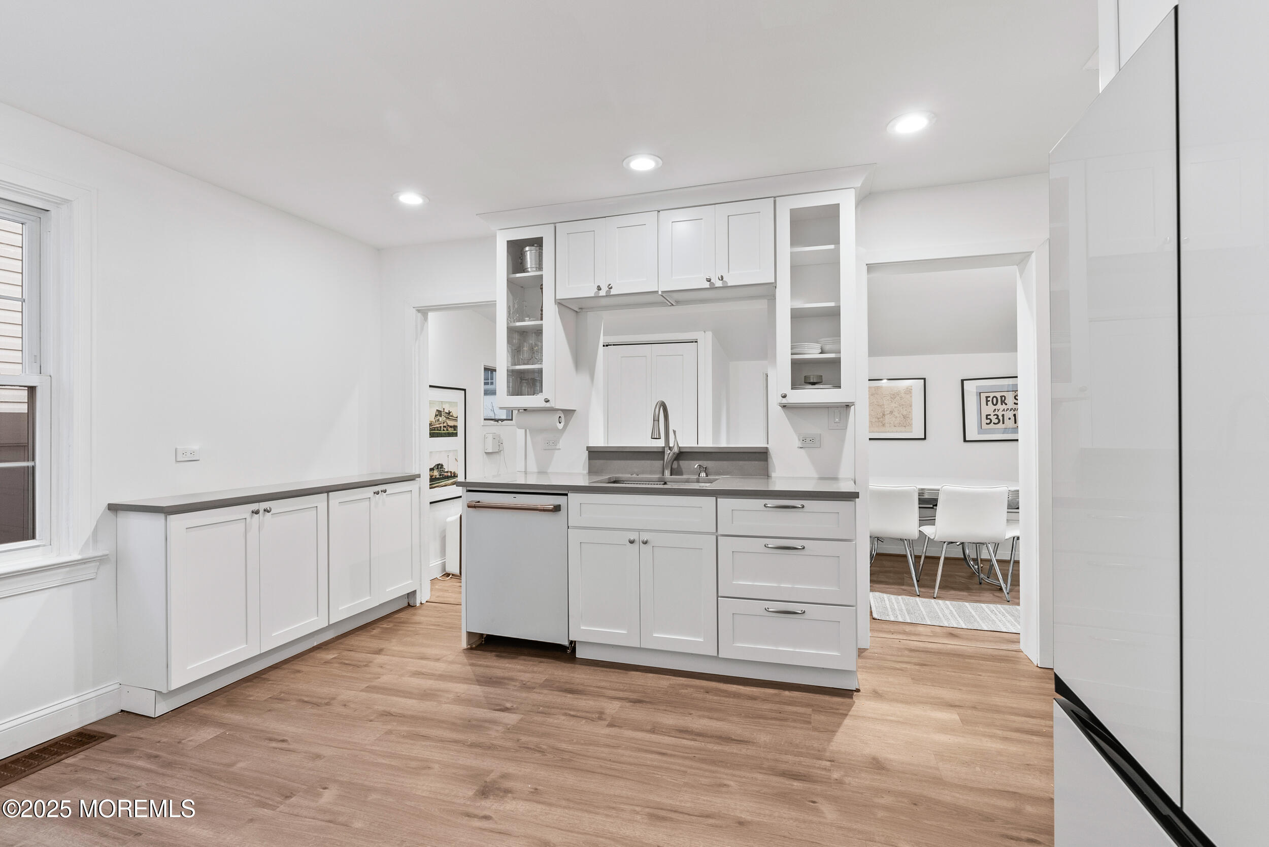90 Deal Esplanade Deal, NJ 07723 - Photo 7 of 25 a kitchen with white cabinets and sink