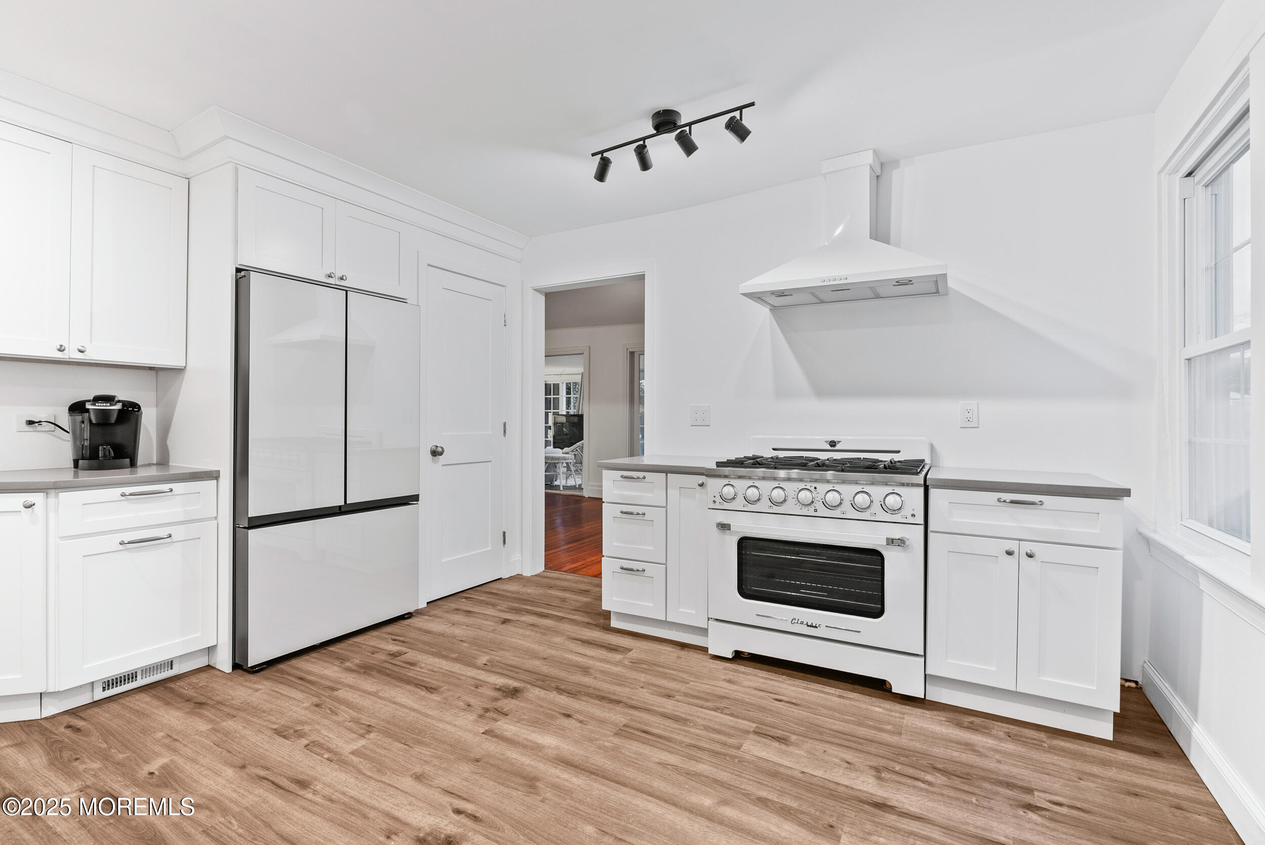 90 Deal Esplanade Deal, NJ 07723 - Photo 9 of 25 a kitchen with cabinets appliances and wooden floor