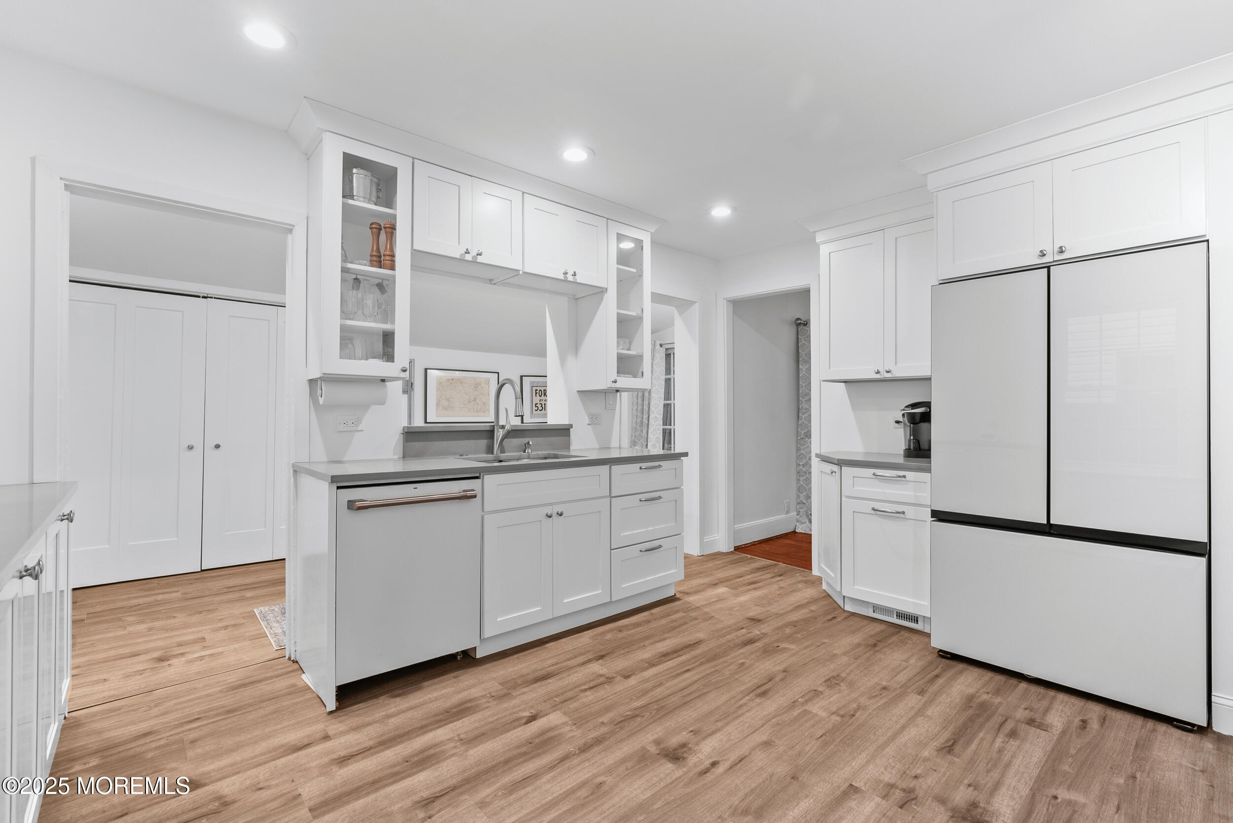 90 Deal Esplanade Deal, NJ 07723 - Photo 10 of 25 a kitchen with white cabinets and white stainless steel appliances
