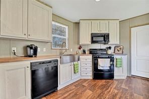 30263 Old Joseph Road Hockley, TX 77447 - Photo 5 of 10 a kitchen with kitchen island granite countertop a stove top oven a sink dishwasher and a refrigerator with wooden floor