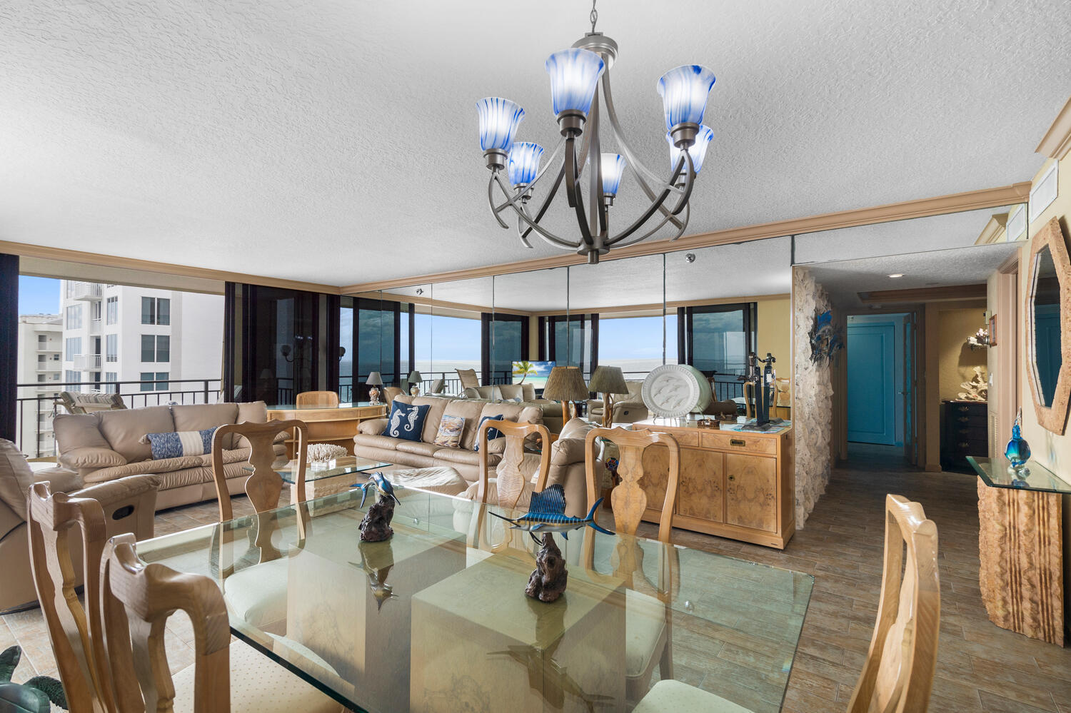 3009 South Ocean Boulevard, Unit 901 Highland Beach, FL 33487 - Photo 17 of 44 a living room with lots of furniture and chandelier