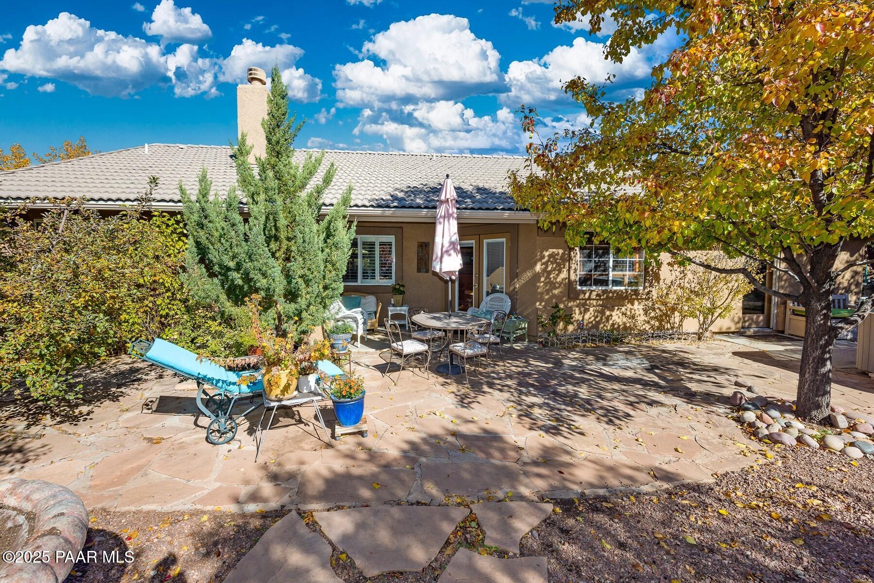 1614 Eagle Mountain Drive Prescott, AZ 86301 - Photo 2 of 8 a view of a patio with table and chairs and potted plants