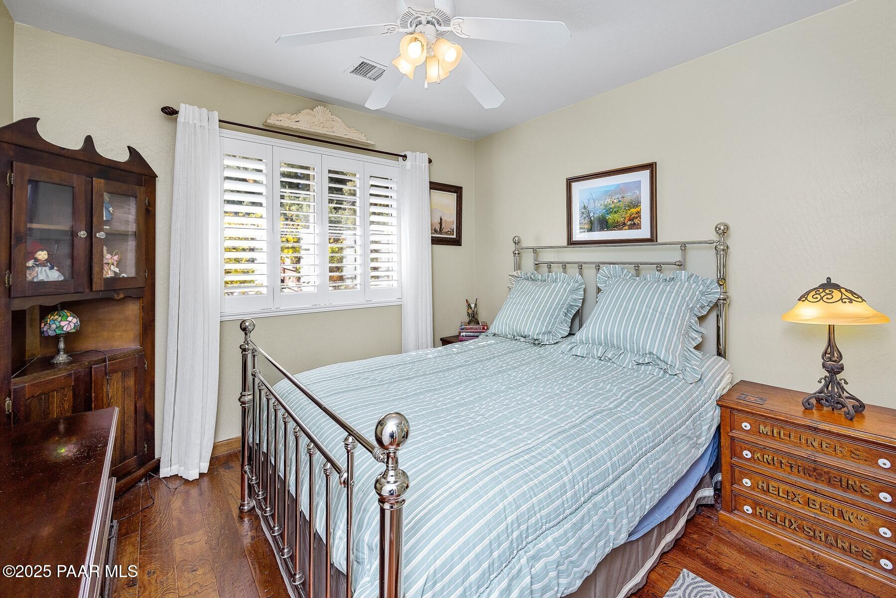 1614 Eagle Mountain Drive Prescott, AZ 86301 - Photo 4 of 8 a bedroom with a bed and a chandelier