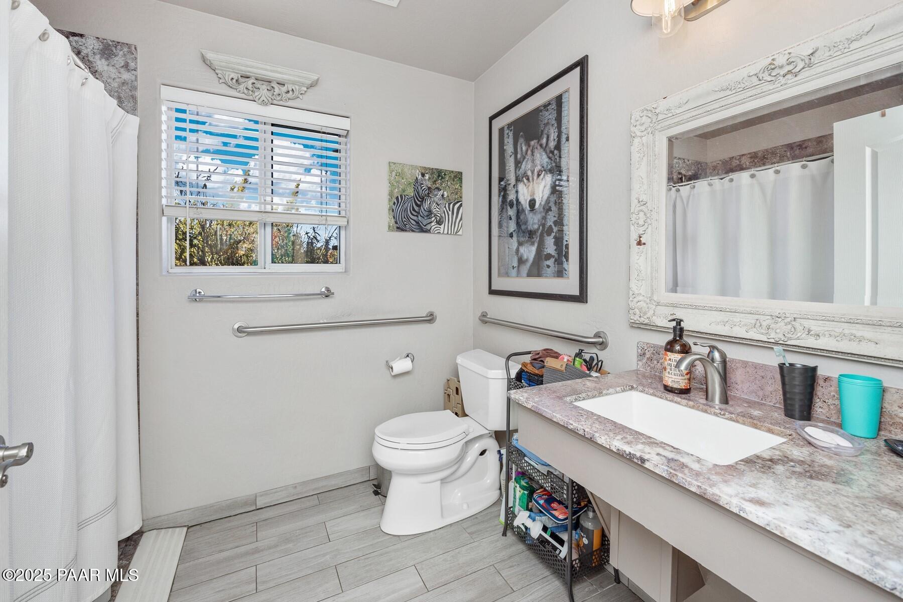 1614 Eagle Mountain Drive Prescott, AZ 86301 - Photo 5 of 8 a bathroom with a granite countertop sink mirror vanity and toilet