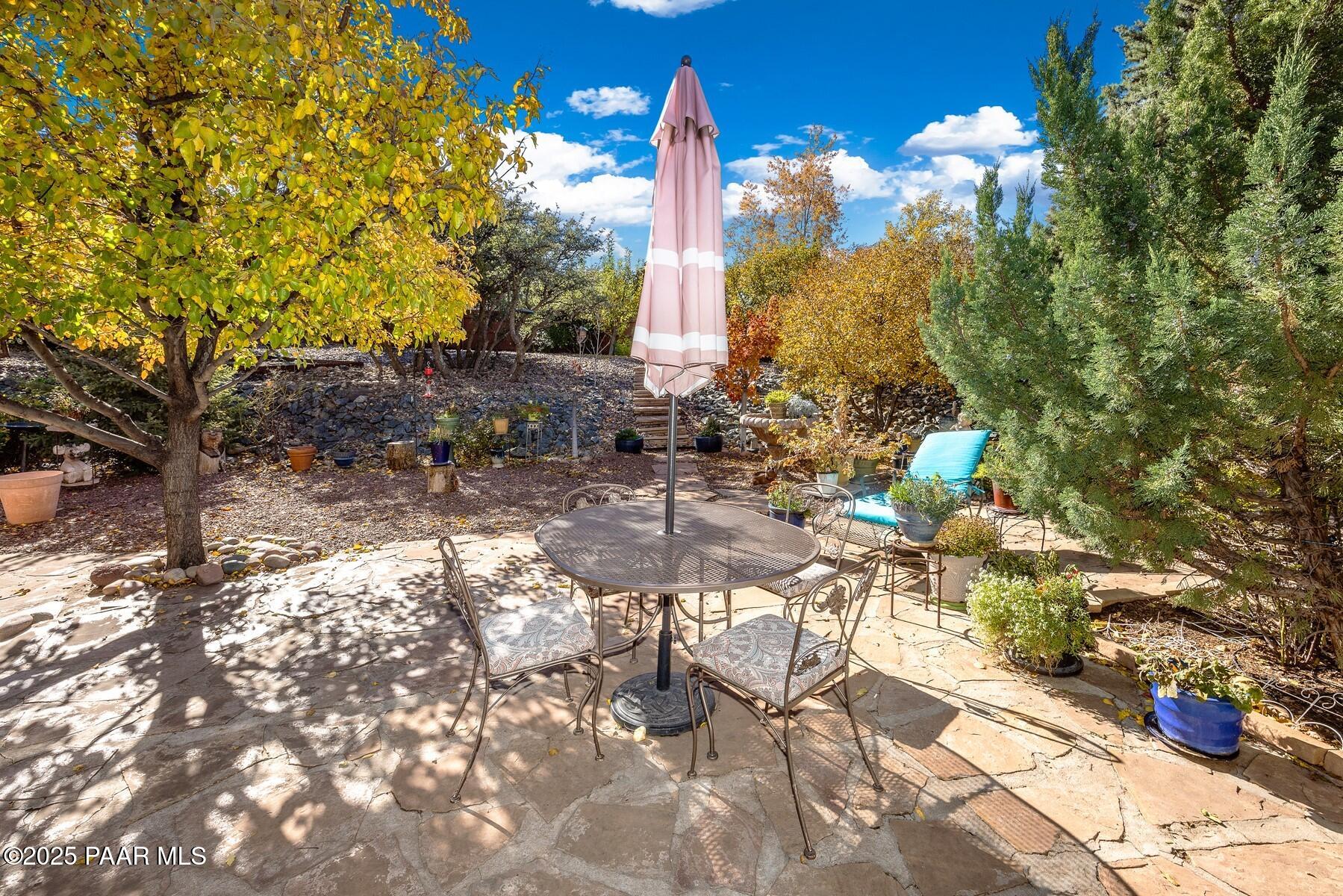 1614 Eagle Mountain Drive Prescott, AZ 86301 - Photo 6 of 8 a backyard of a house with table and chairs