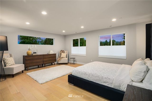 a bathroom with a tub a mirror and shower