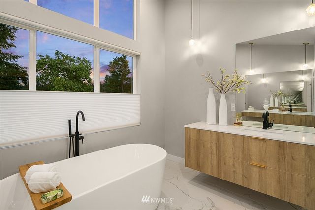 a bedroom with a bed and a large window with the outer view