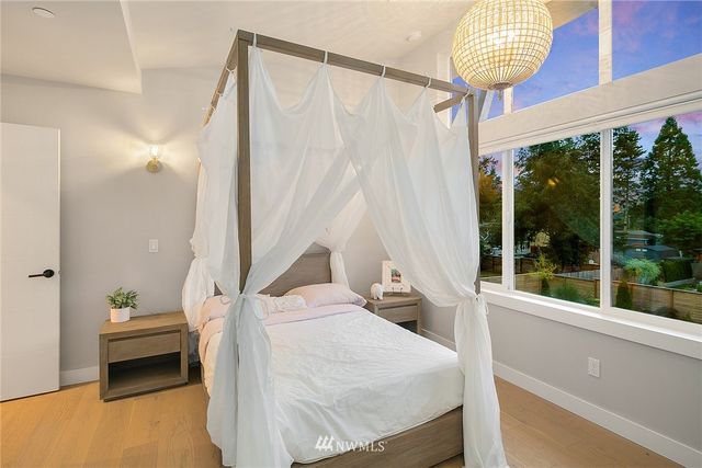 a bedroom with furniture and a large window