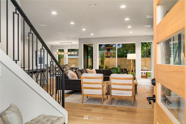 a living room with large windows and furniture