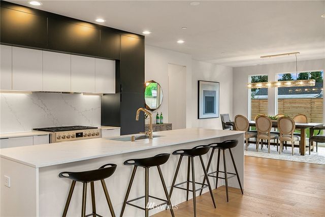 a kitchen with a table chairs and a stove