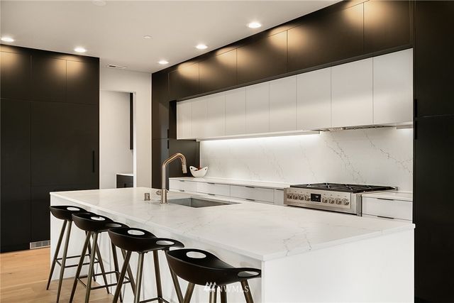 a kitchen with counter top space and windows