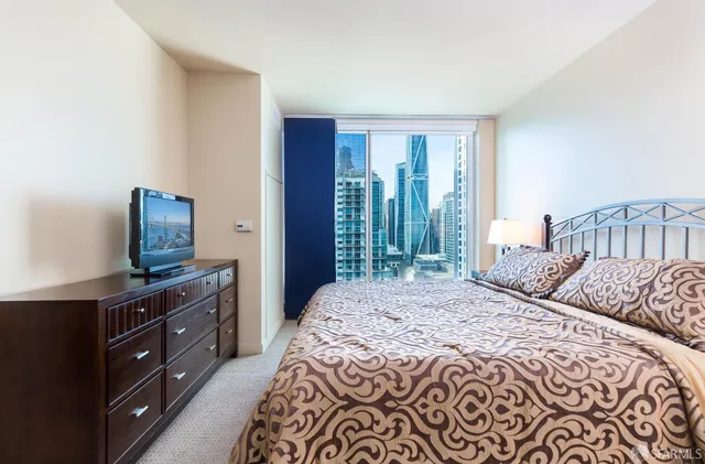 a bedroom with a bed and a dresser in it