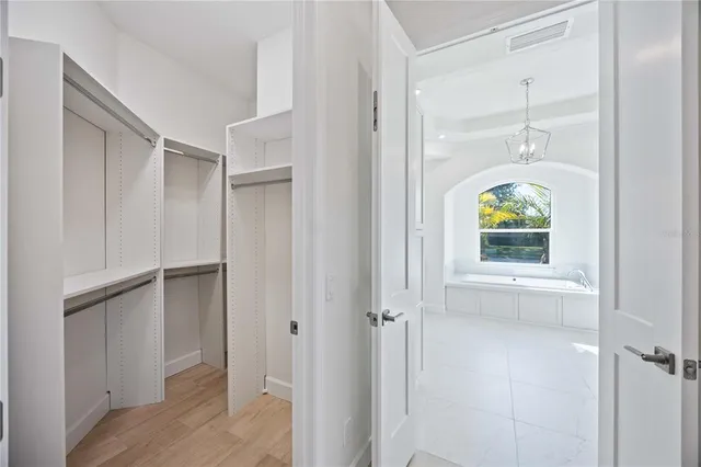 an empty room with windows and closet