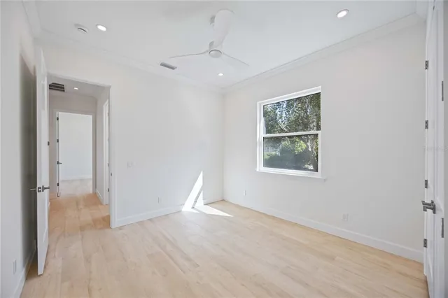 an empty room with windows and closet