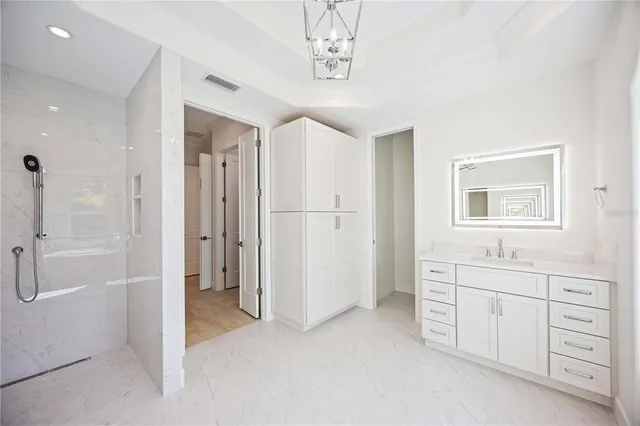 a spacious bathroom with a shower and a sink