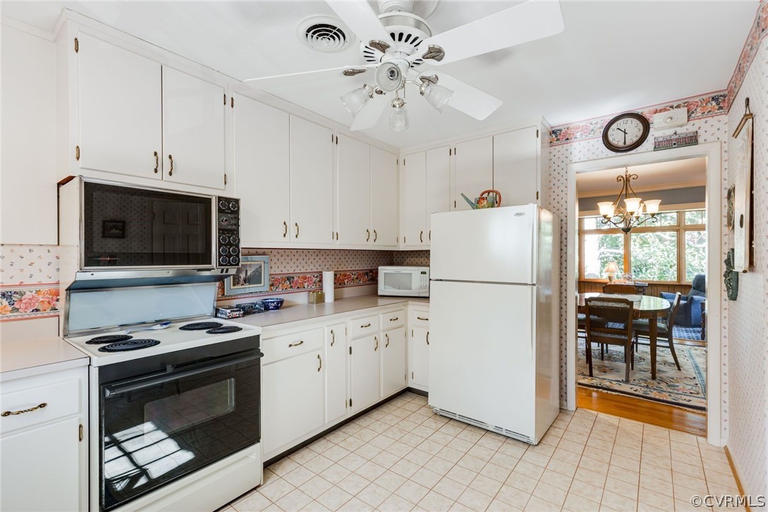 6161 River Road, Unit 37 Richmond, VA 23226 - Photo 14 of 24 a kitchen with a stove a sink and a microwave