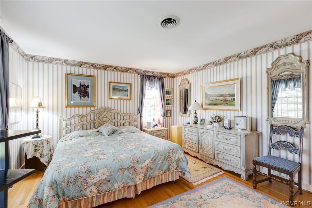6161 River Road, Unit 37 Richmond, VA 23226 - Photo 18 of 24 a spacious bedroom with a bed and wooden floor
