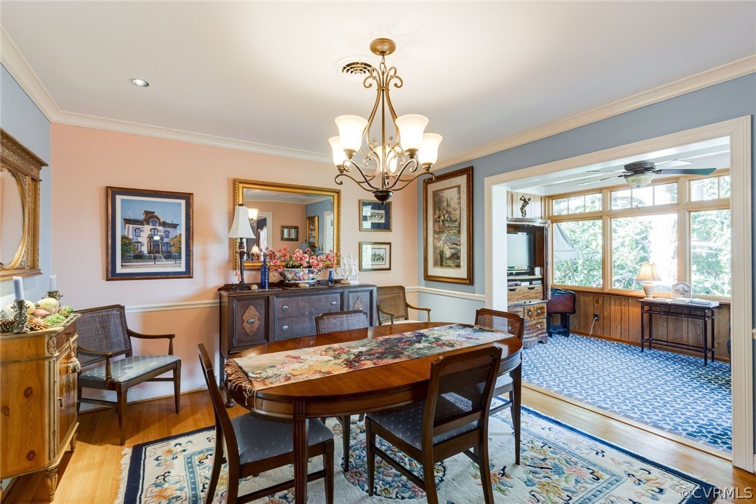 6161 River Road, Unit 37 Richmond, VA 23226 - Photo 10 of 24 a dining room with wooden floor a chandelier a wooden table and chairs