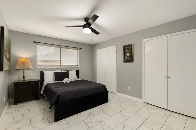 a bedroom with a bed and wooden floor