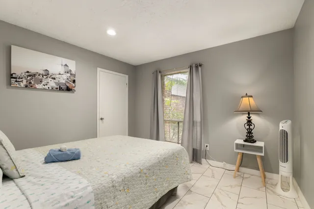 a bedroom with a bed and a painting on the wall