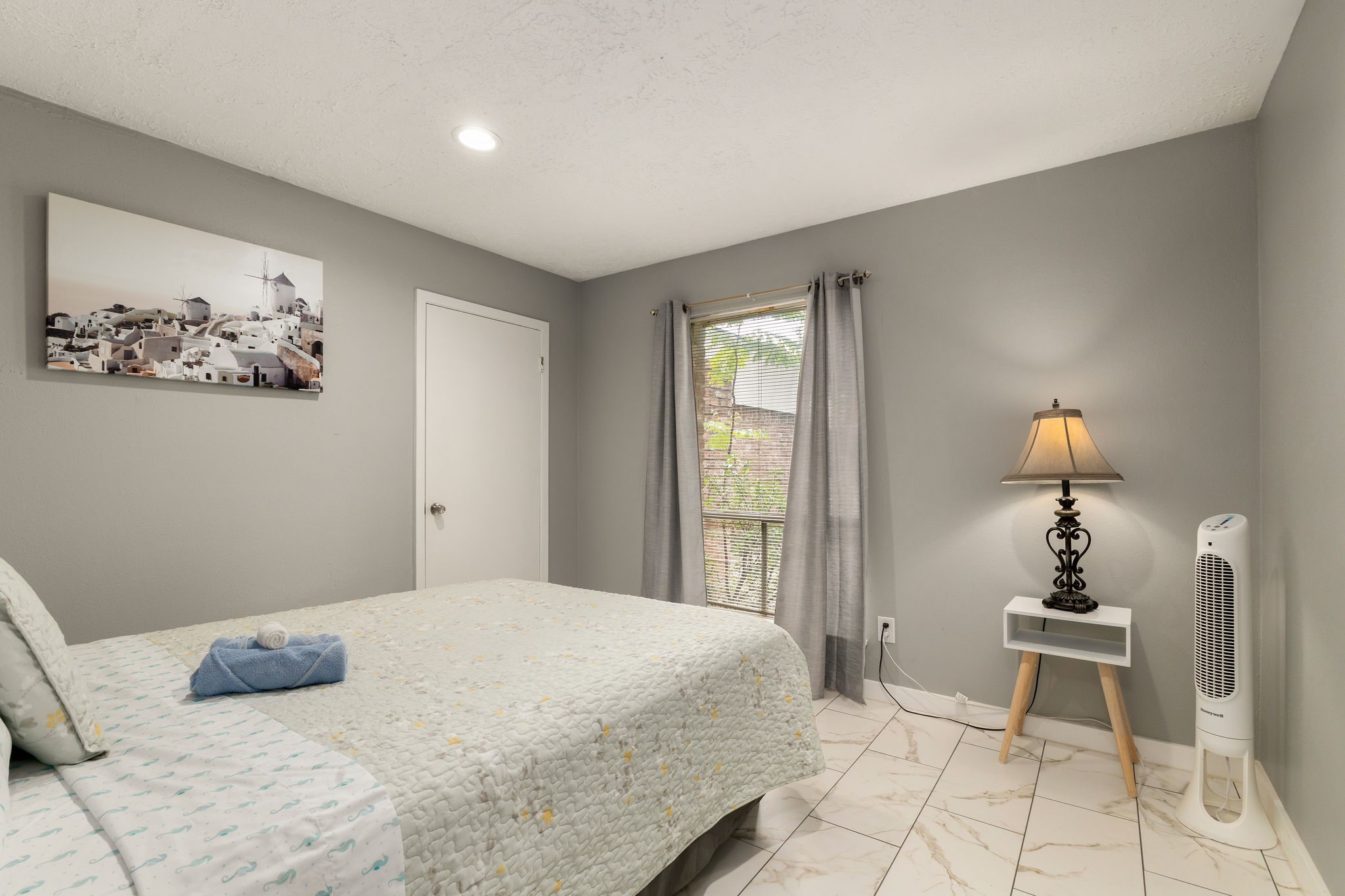 14110 Eventide Drive Cypress, TX 77429 - Photo 17 of 27 This bedroom features a cozy bed with light bedding, tiled flooring, and neutral gray walls. A simple piece of artwork can add charm, and recessed lighting provides a modern touch.
