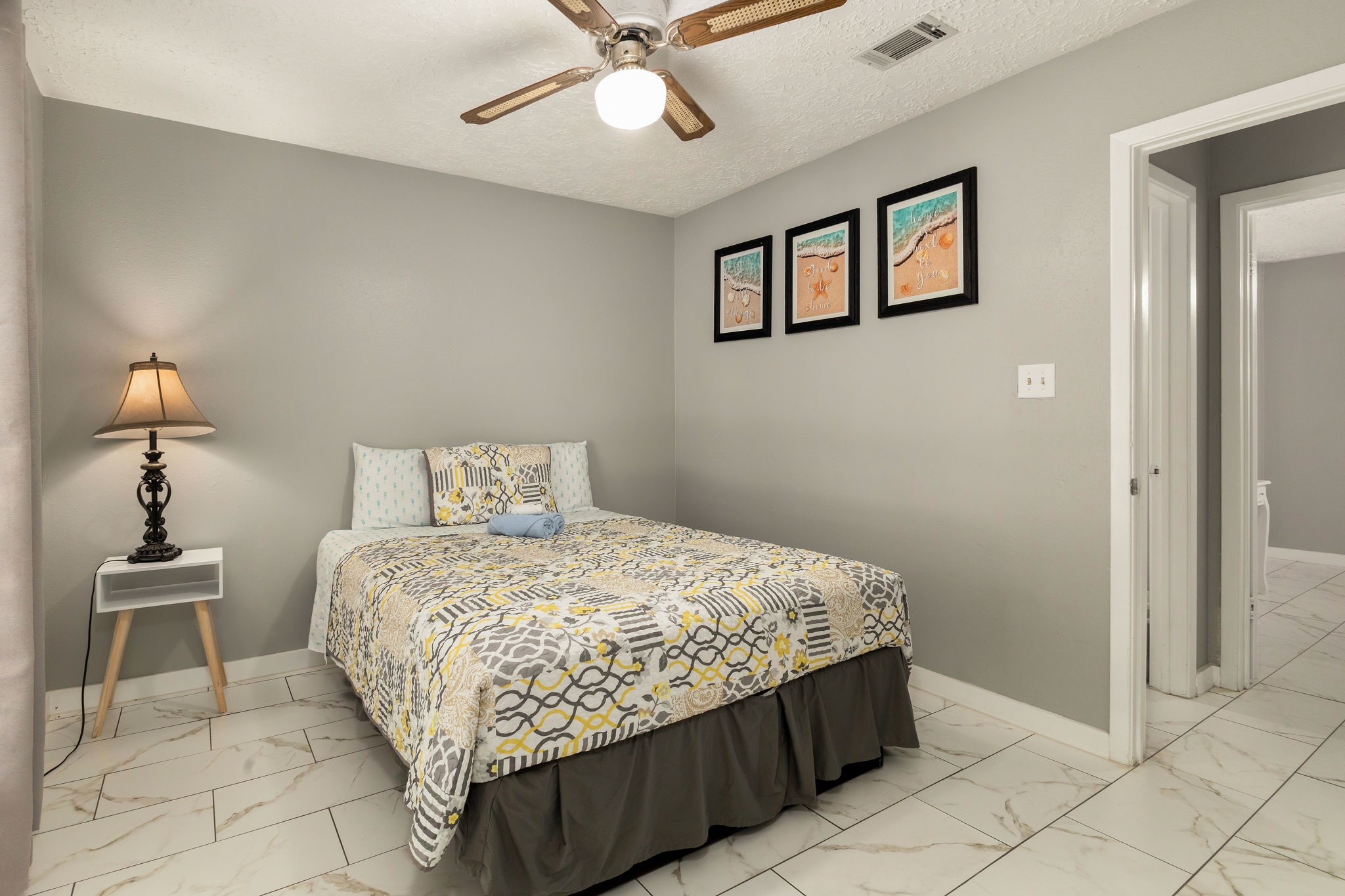 14110 Eventide Drive Cypress, TX 77429 - Photo 20 of 27 This bedroom features neutral gray walls and a ceiling fan. Along with the tile flooring and offers a simple, cozy atmosphere.