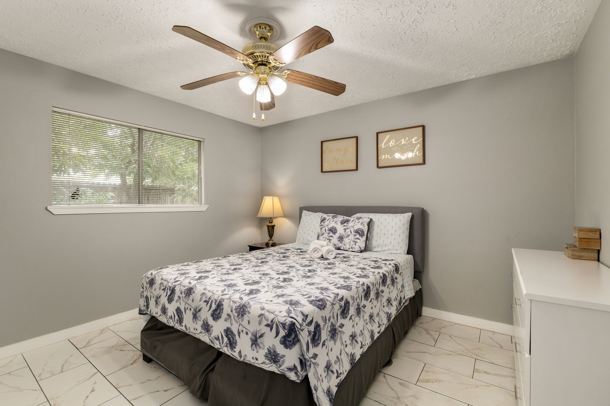 14110 Eventide Drive Cypress, TX 77429 - Photo 22 of 27 This bedroom features neutral gray walls and a ceiling fan. Along with the tile flooring and offers a simple, cozy atmosphere.