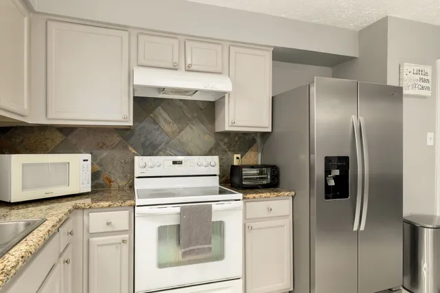 a kitchen with stainless steel appliances cabinets and a counter space